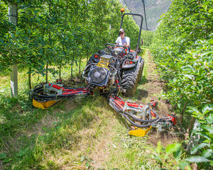Smalspoortractor met Ilmer GT-Vario front-werktuigendrager werkt aan beide zijden van de boomrij